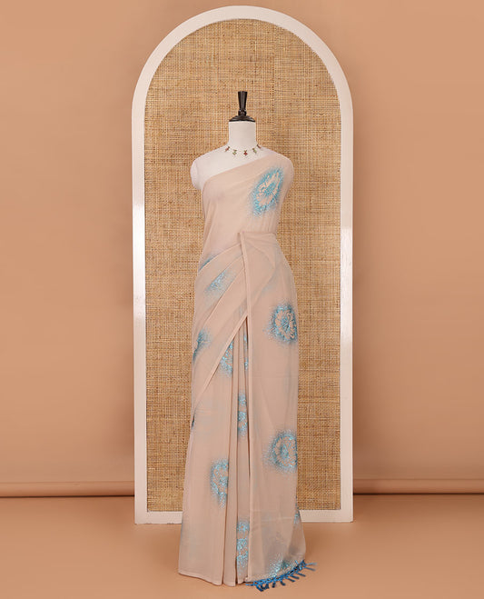 Borderless cream 60 gm georgette saree features floral vine designs, glitter embroidery work, contrast plain blouse