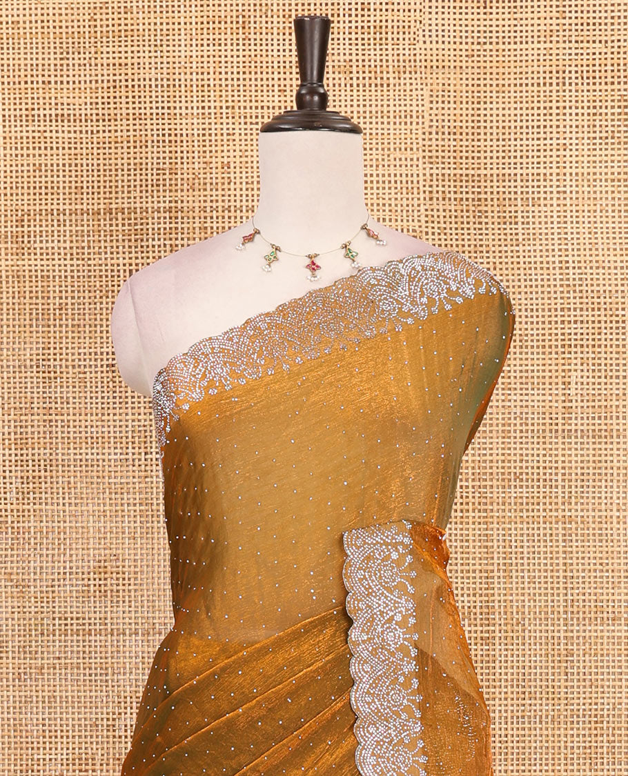 Mustard Swarovski crystal stone embedded fendy chiffon saree, scallop border accentuated with floral and scallop design in Swarovski stones