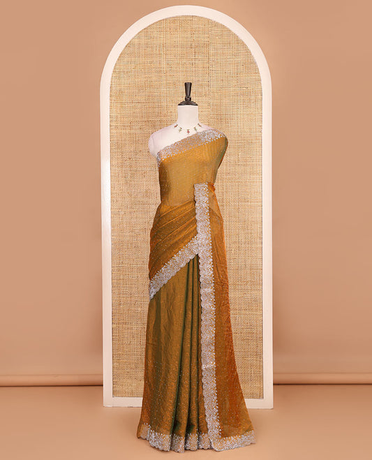 Mustard Swarovski crystal stone embedded fendy chiffon saree, scallop border accentuated with floral and scallop design in Swarovski stones