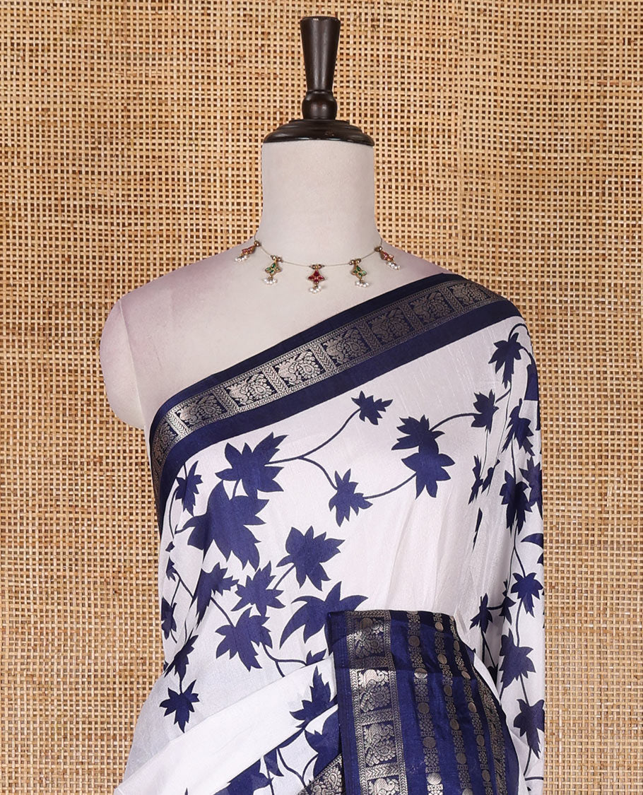 Navy blue leaf motifs printed dola silk saree, contrast traditional zari border of Rudraksham and peacock motifs, geometric printed pallu and contrast printed blouse