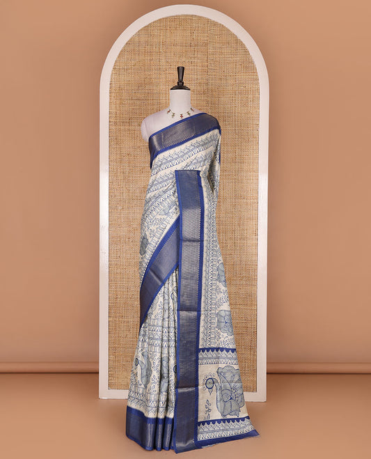 Cream-blue flora, fauna, and geometric madhubani printed soft tussar saree, contrast zari border, peacock print pallu, and printed blouse