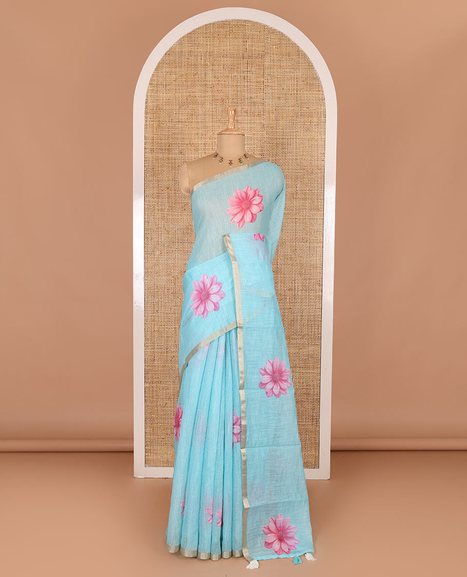 Sea blue daisy floral printed linen cotton saree, gold zari piping border, daisy floral printed pallu, and matching floral printed blouse