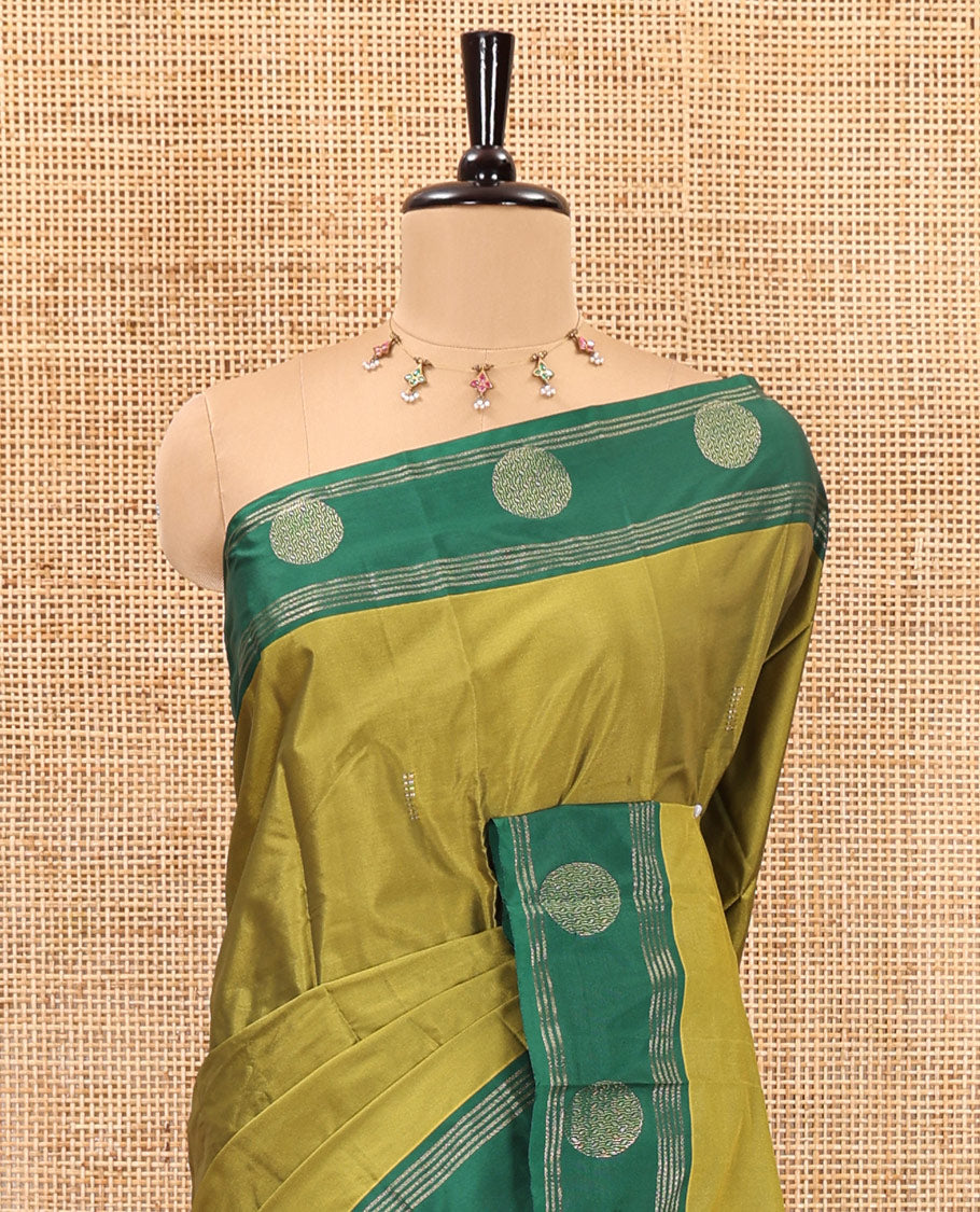 Olive Green dobby style buttas semi-soft silk saree, contrast round buttas and striped border, striped pallu, and a plain blouse