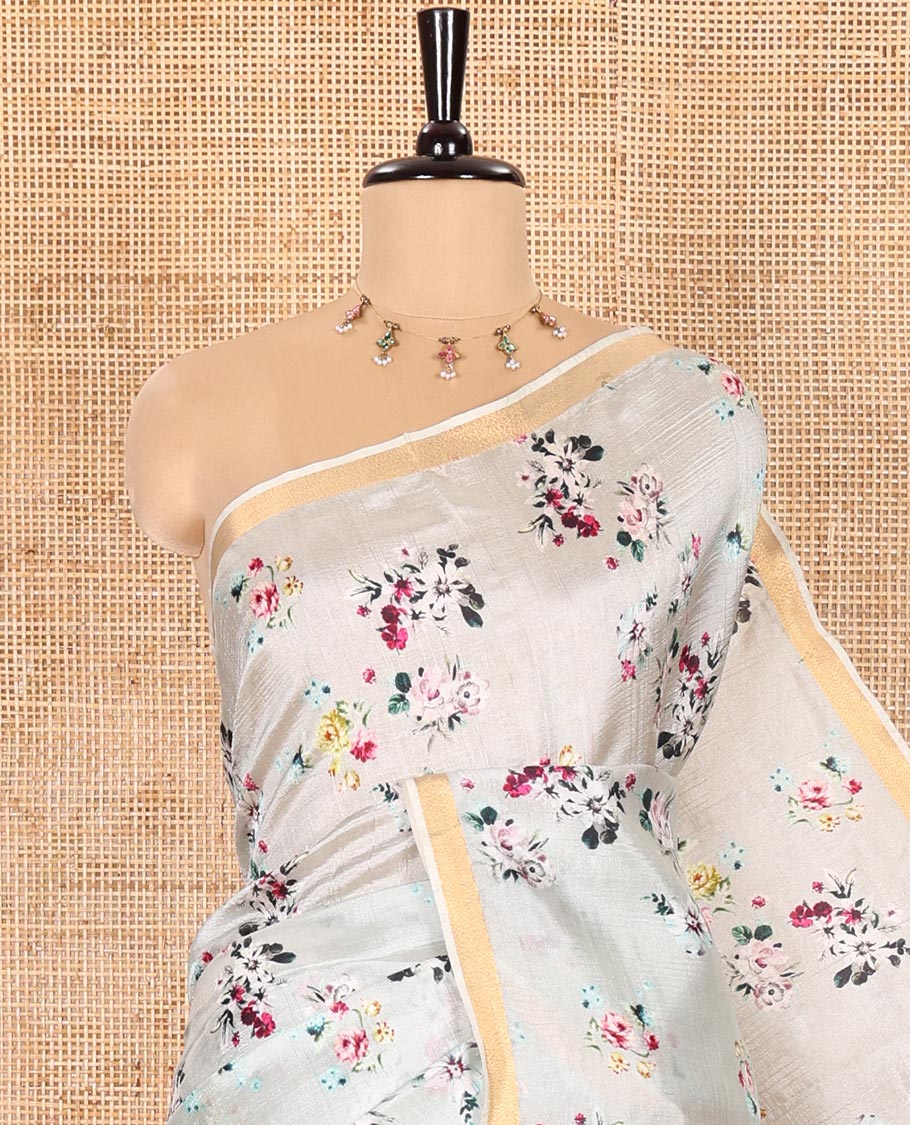 Grey Banana Pith Saree Prettified with Multi-Color Floral Vine Print, Subtle Small Bavanji Border, Gleaming Zari Striped Pallu, and Complemented with a Contrast Floral-Printed Blouse