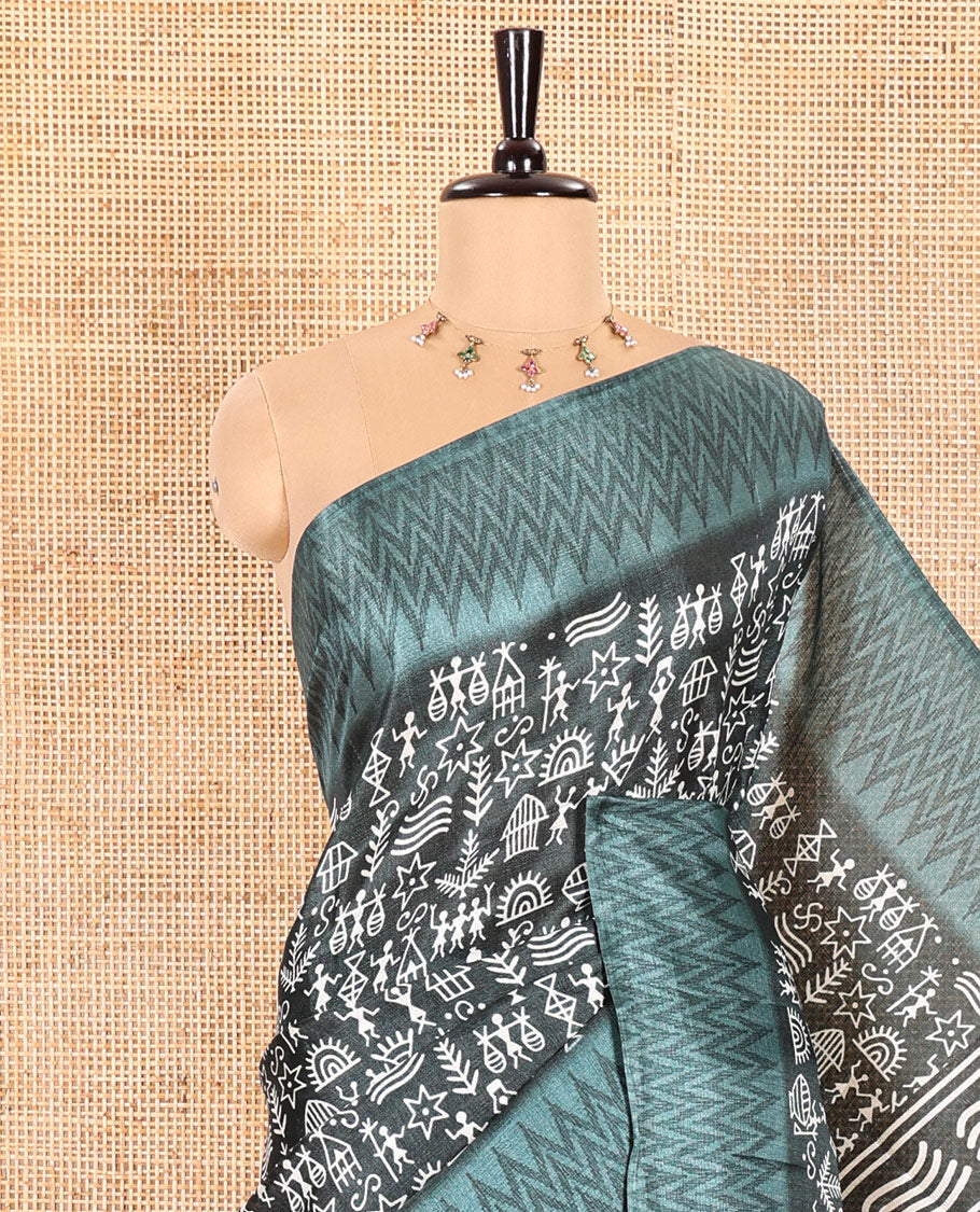 Green Art Khadi Cotton Saree Adorned with Warli-Village Theme Print, Complemented with a Contrasting Chevron-Printed Border, Vibrantly Warli-Printed Pallu, and a Plain Blouse
