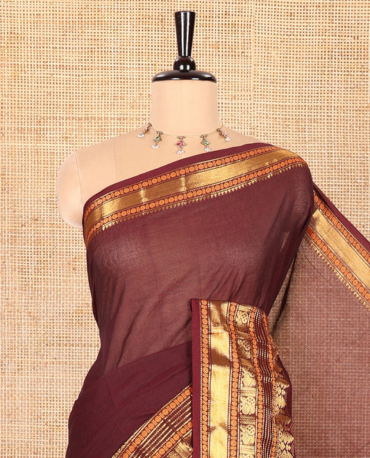 Coffee Brown Plain Chettinad Cotton Saree, Highlighted by Sparkling Traditional Zari Border of Peacock and Rudraksham Designs, Subtly Striped Pallu, and Paired with a Matching Blouse