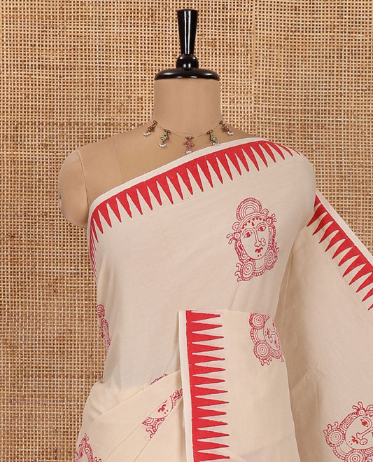Cream South Cotton Saree, Elevated with Kalamkari-Style Figurine Motifs, Block Printed on  Its Body, Highlighted by Temple Printed Border, Comes with a Matching Blouse, and a Captivating Contrast Floral Vine Printed Blouse