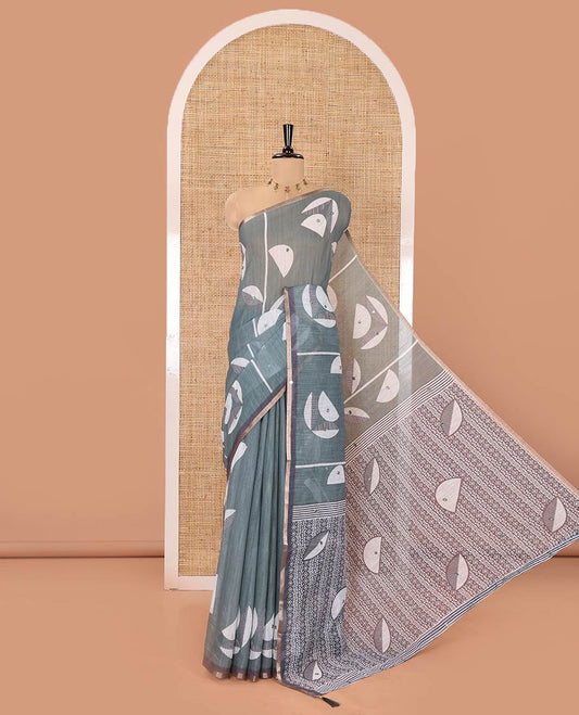 Green Linen Saree, Elevated with Geometric Print and Mirror Work on Its Body, Subtle Piping Border, Pallu Steeped with Geometric Patterns, and Paired with Unique Motifs Printed Contrast Blouse