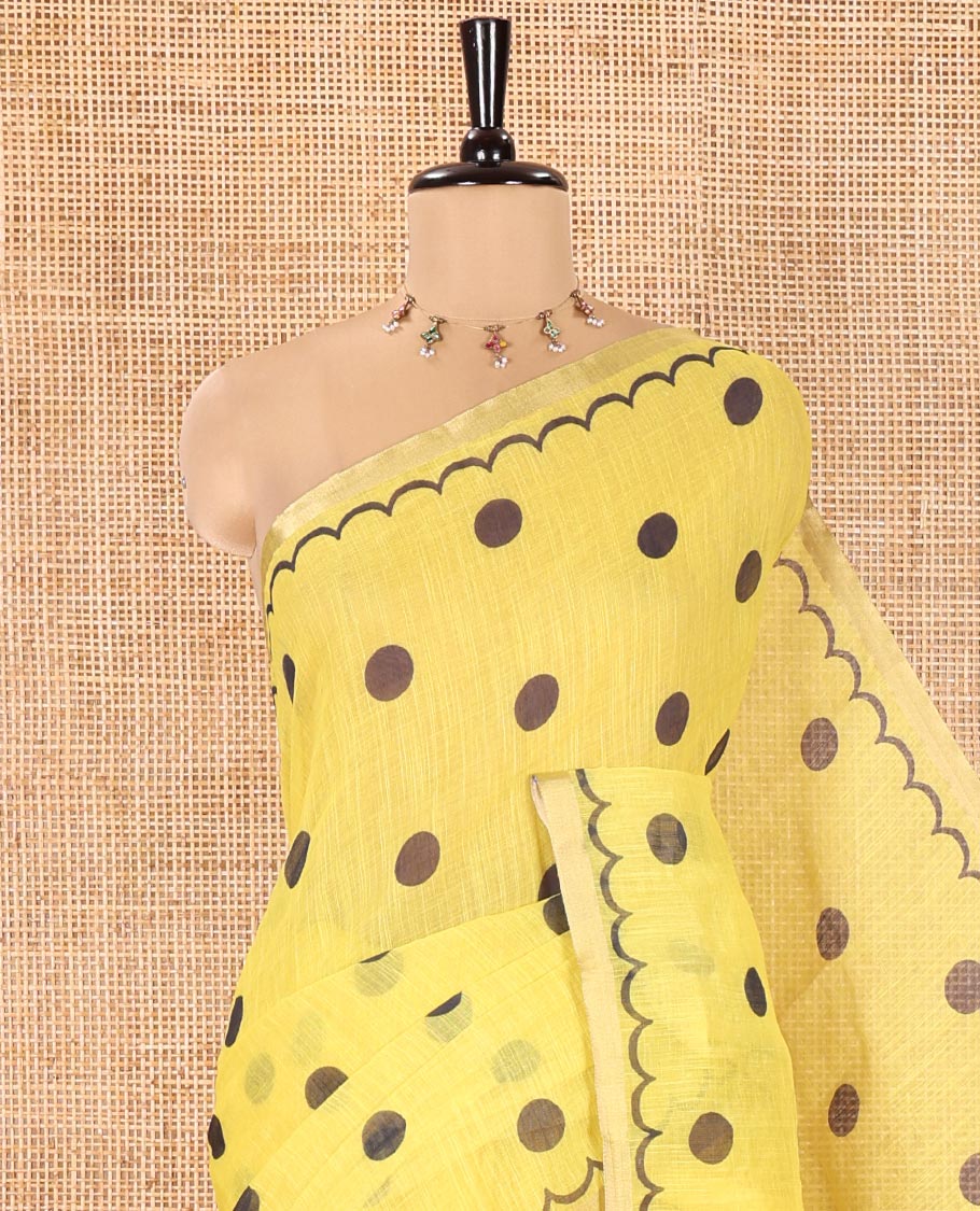 Yellow Linen Cotton Saree, Beautified with Polka Dots All Over Its Body, Subtle Piping Border, Self-Pallu, and Paired with a Floral Printed Matching Blouse