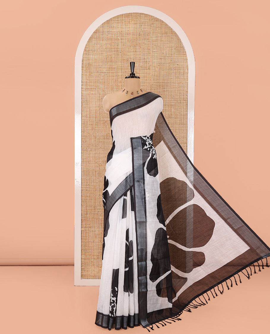 White Linen Cotton Saree, Adorned with Big Floral Prints On Its Body, Complemented by Contrast Zari Bavanji Border, Floral Printed Pallu, and Paired with a Hand Block Printed Blouse