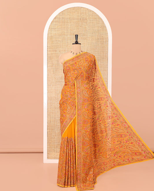 Mustard Georgette Saree, Ornamented with Intricate Paisleys, Kashmir Embroidered and Stone Work on Its Body, a Self-Embroidered Border, and Paired with an Embroidered Blouse