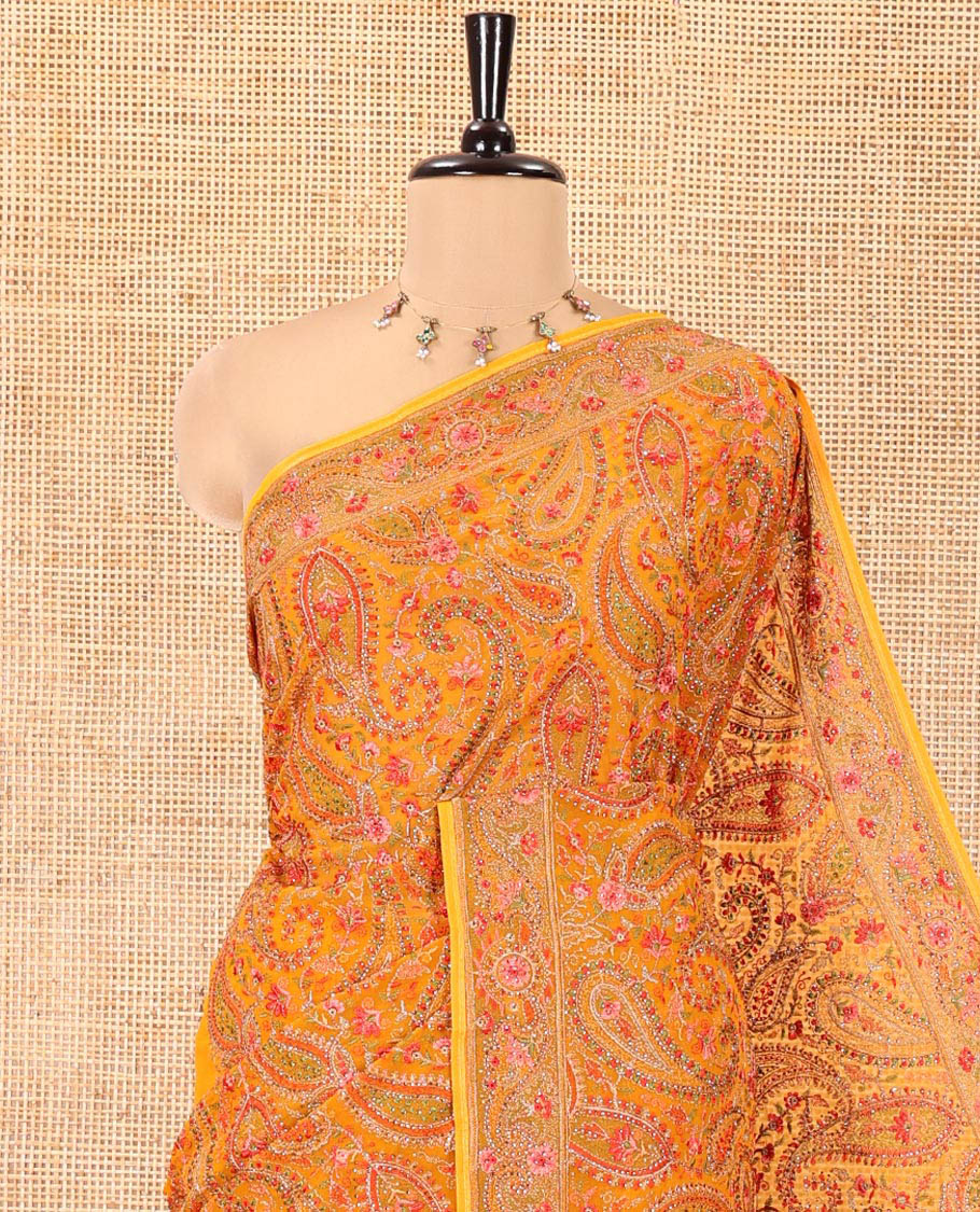 Mustard Georgette Saree, Ornamented with Intricate Paisleys, Kashmir Embroidered and Stone Work on Its Body, a Self-Embroidered Border, and Paired with an Embroidered Blouse