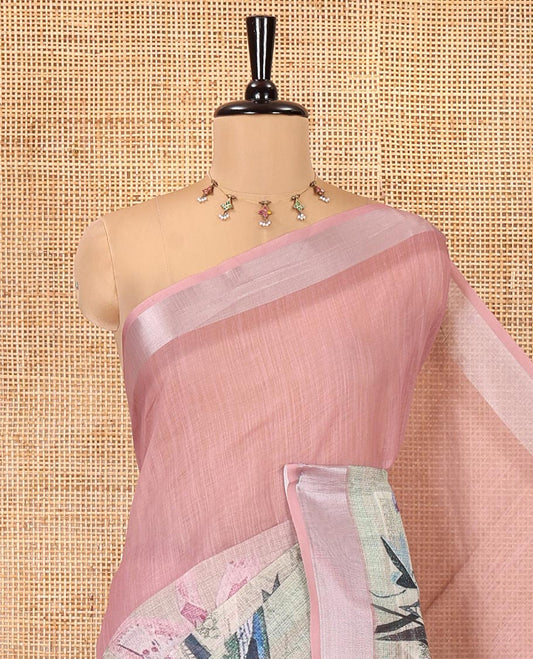 Green and Dusky Pink Linen Cotton Saree, Creatively Designed with Tropical Floral, and Newspaper-Texture Printed on Its Body, Complemented by a Silver Tissue Border, a Self-Printed Pallu, and Paired with a Matching Blouse