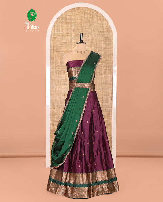 Purple-Green Semi-Banarasi Half-Saree Enthralled with Zari Buttas on Its Skirt, Complemented by a Contrast Traditional Zari Temple Rettai Pettu Border, Paired with a Matching Blouse, and a Satin Georgette Embroidered Scallop Dhavani