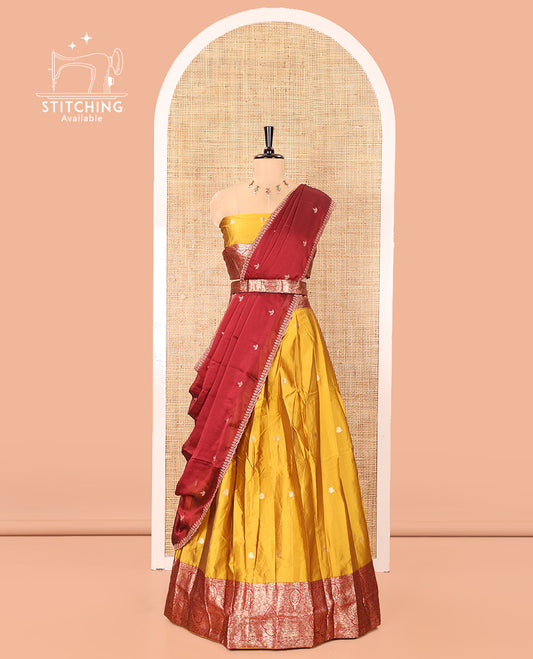 Yellow and Red Semi-Banarasi Half-Saree, Accentulated with Zari Buttas on Its Skirt, Complemented by a Contrast Intricately Zari-Designed Border, Paired with a Matching Blouse, and a Contrast Satin Georgette Embroidered Scallop Dhavani