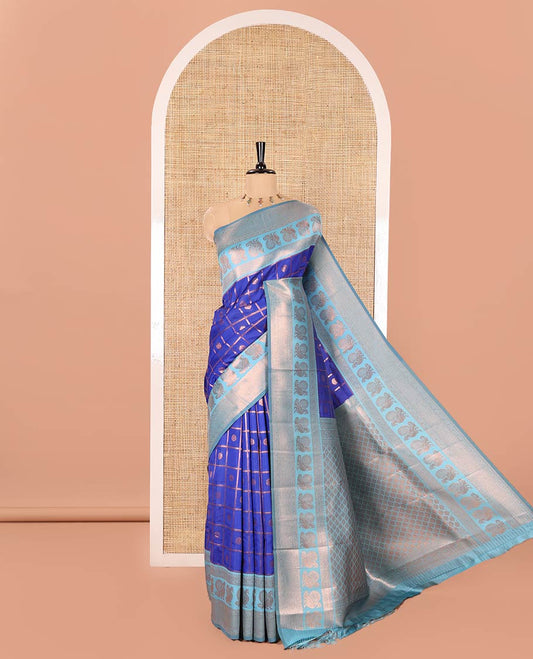 Blue Litchi Saree, Embellished with Zari Buttas Enclosed Checks on Its Body, Complemented by a Contrast Traditional Zari Border of Peacock Designs, Grand Jaal Pallu, and Paired with a Contrast Blouse