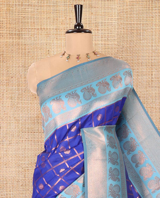Blue Litchi Saree, Embellished with Zari Buttas Enclosed Checks on Its Body, Complemented by a Contrast Traditional Zari Border of Peacock Designs, Grand Jaal Pallu, and Paired with a Contrast Blouse
