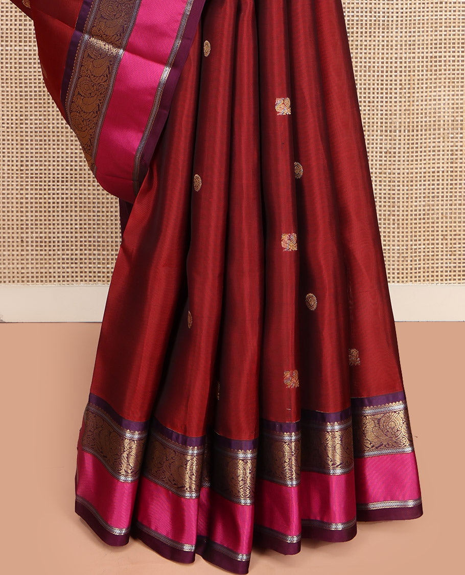 Maroon Vasundhara Lite Silk Mix Saree, Accentuated with Annam Chakram Zari Buttas, Complemented by a Contrast Rettai Pettu Border of Rekku, Kathir, and Mayil Designs, Meticulously Designed Pallu, and Paired with a Contrast Blouse