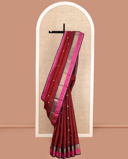 Maroon Vasundhara Lite Silk Mix Saree, Accentuated with Annam Chakram Zari Buttas, Complemented by a Contrast Rettai Pettu Border of Rekku, Kathir, and Mayil Designs, Meticulously Designed Pallu, and Paired with a Contrast Blouse