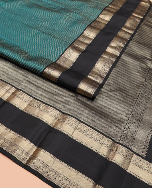 Peacock blue zari striped silk saree, contrast rettai pettu border of salngai, rudraksham, star, mayil, yaanai, and mayil kann designs, and geometric patterned pallu