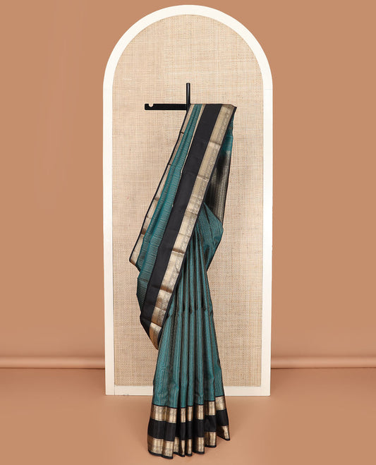 Peacock blue zari striped silk saree, contrast rettai pettu border of salngai, rudraksham, star, mayil, yaanai, and mayil kann designs, and geometric patterned pallu