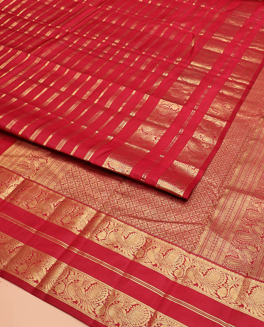 Red Vasundhara Silk Saree Majestically Detailed with Zari Designs, Highlighted by a Zari Border of Muthu, Banaras, and Mayil Designs, Grandly Detailed Pallu of Jaal Design, and a Matching Blouse