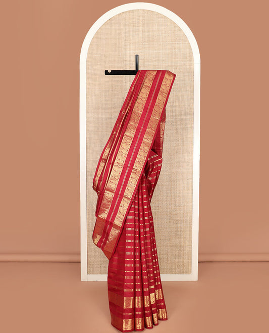 Red Vasundhara Silk Saree Majestically Detailed with Zari Designs, Highlighted by a Zari Border of Muthu, Banaras, and Mayil Designs, Grandly Detailed Pallu of Jaal Design, and a Matching Blouse