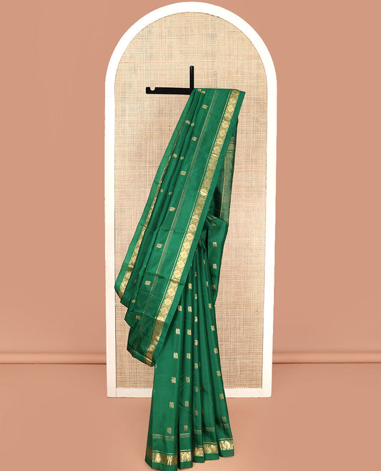 Green Vasundhara Lite Silk Mix Saree, Artfully Detailed with Zari Buttas on Its Body, Highlighted by a Zari Border of Rekku, Muthu, and Poun Designs, Grandly Decked Up Jaal-Patterned Pallu, and Paired with a Matching Blouse