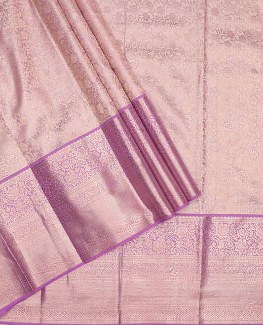 Pink pure-silk half-saree, jacquard skirt, contrast blouse, and border of rekku, poun, floral, kuyil kann, diamond, and then kuli kann designs, and intricate dhavani