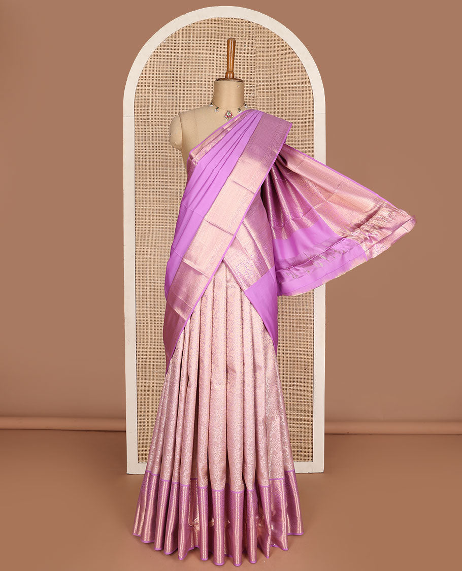 Pink pure-silk half-saree, jacquard skirt, contrast blouse, and border of rekku, poun, floral, kuyil kann, diamond, and then kuli kann designs, and intricate dhavani