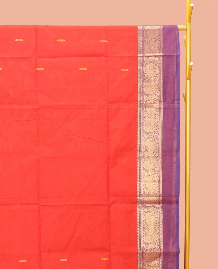 Red Chettinad Cotton Saree, Delicately Woven with Thread Buttas All Over Its Body, Complemented by a Contrast Ganga-Jamuna Kal Eragina Border of Kodi Peacock and Elephant Designs, Pallu of Buttas and Stripes, and Paired with a Matching Blouse