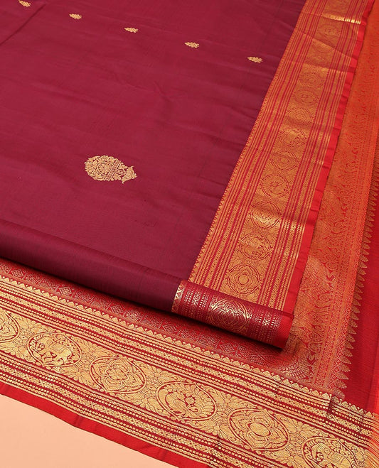 Maroon Kanchipuram Silk Saree, Bedecked with Zari Buttas All Over Its Body, Complemented by a Contrast Border of Neli, Muthu, Cross Kamalam, and Mayil Designs, Pallu of Butta Enclosed Checked Designs, and Paired with a Contrast Blouse
