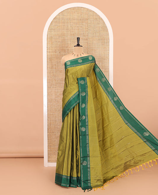 Olive Green dobby style buttas semi-soft silk saree, contrast round buttas and striped border, striped pallu, and a plain blouse
