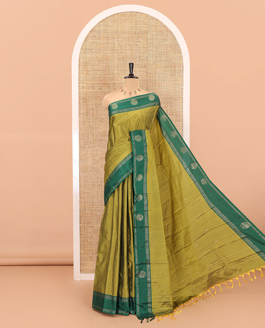 Olive Green dobby style buttas semi-soft silk saree, contrast round buttas and striped border, striped pallu, and a plain blouse