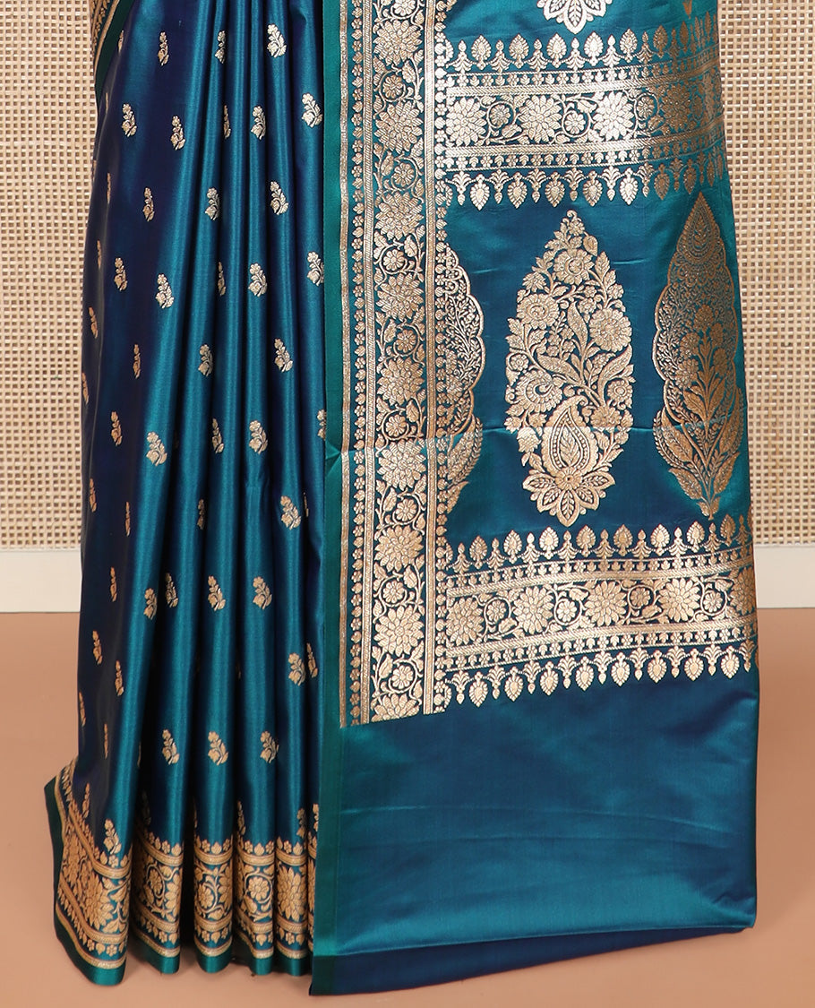 Blue Semi-Banaras Satin Saree Subtly Sparkled with Zari Buttas, Self-Border Gleamed Up with Floral Creeper Designs, Pallu Intricately Designed with Mughal-Style Floral Designs, and Paired with a Matching Blouse