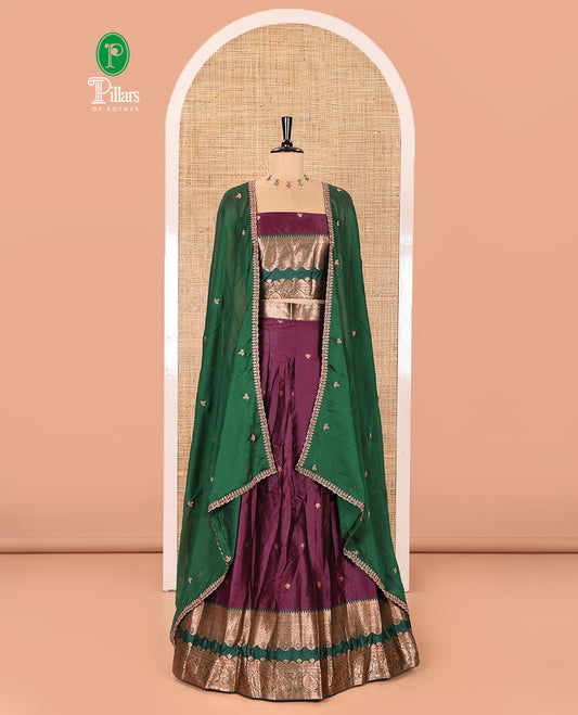 Purple-Green Semi-Banarasi Half-Saree Enthralled with Zari Buttas on Its Skirt, Complemented by a Contrast Traditional Zari Temple Rettai Pettu Border, Paired with a Matching Blouse, and a Satin Georgette Embroidered Scallop Dhavani