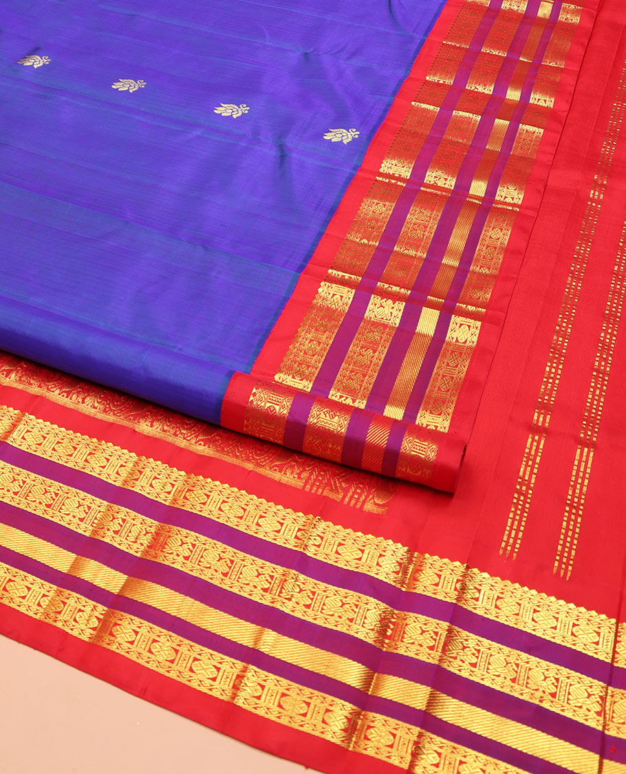 Blue Kanchipuram Silk Saree, Meticulously Crafted with Zari Buttas on Its Body, Complemented by Contrast One-Sided Border of Thilakam Mokku, Neli, Rudraksham, and Mayil Designs, Grandly Woven Pallu of Floral Designs, and Comes Without a Blouse