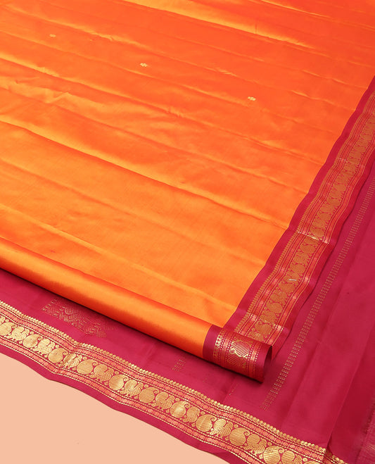 Orange Kanchipuram Silk Saree Prettified with Zari Buttas, Complemented by Contrasting Border of Thilakam Mokku, Muthu, Rudraksham, Mayil and Manga Designs, Pallu Mirroring the Same Border Design, and Paired with a Contrast Blouse