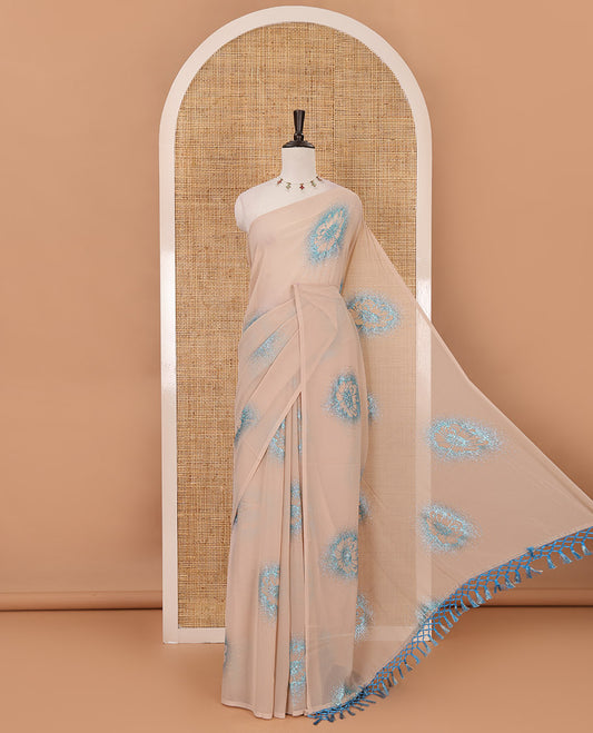 Borderless cream 60 gm georgette saree features floral vine designs, glitter embroidery work, contrast plain blouse