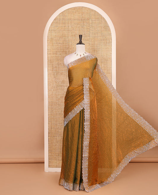 Mustard Swarovski crystal stone embedded fendy chiffon saree, scallop border accentuated with floral and scallop design in Swarovski stones