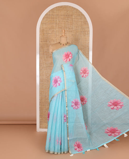 Sea blue daisy floral printed linen cotton saree, gold zari piping border, daisy floral printed pallu, and matching floral printed blouse