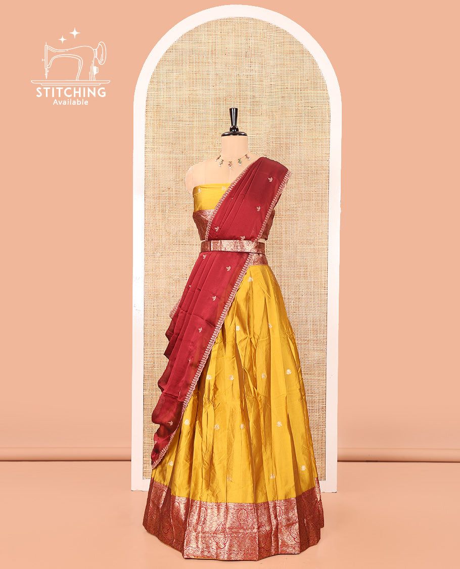 Yellow and Red Semi-Banarasi Half-Saree, Accentulated with Zari Buttas on Its Skirt, Complemented by a Contrast Intricately Zari-Designed Border, Paired with a Matching Blouse, and a Contrast Satin Georgette Embroidered Scallop Dhavani