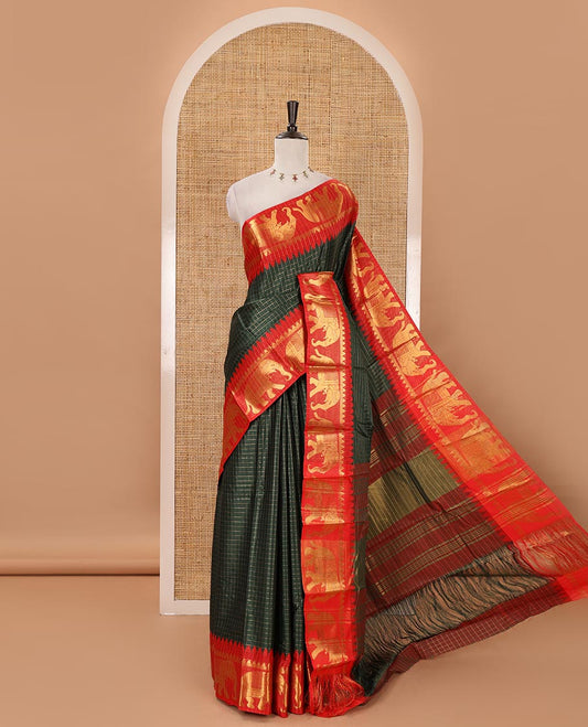 Bottle green checked semi-tafeta saree, contrast temple zari elephant motifs border, striped pallu & matching checked zari border blouse