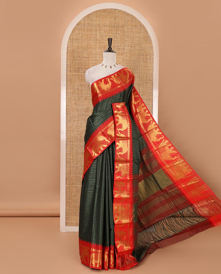 Bottle green checked semi-tafeta saree, contrast temple zari elephant motifs border, striped pallu & matching checked zari border blouse