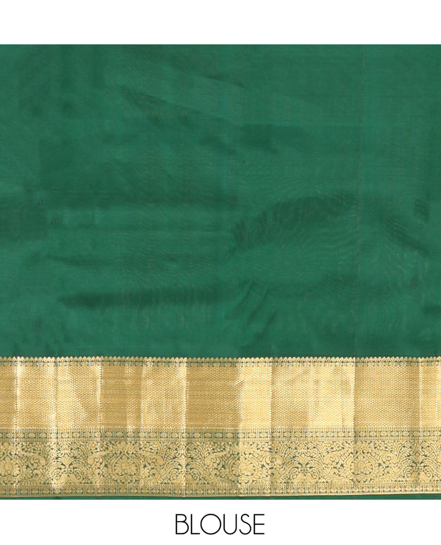 Green Vasundhara Silk Saree, Woven with Zari Buttas, a Zari Thazampoo Rekku Border of Kuyil Kann, Muthu, Star Vanki, and Jada Nagam Designs, Grand Pallu, and a Matching Blouse