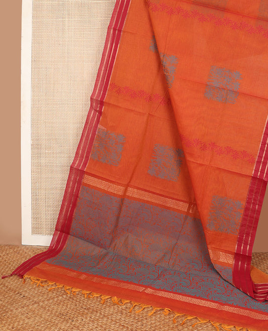 Orange Combatiore cotton saree with floral buttas, contrast striped border & floral design pallu