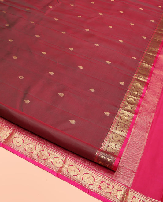 Red Wine Kanchipuram Silk Saree, Adorned with Thilakam Buttas All Over Its Body, Complemented by a Contrast Border of Rekku, Muthu, Banaras, Mayil, and Chakram Designs, Grand Jaal Pallu, and Paired with a Contrast Blouse