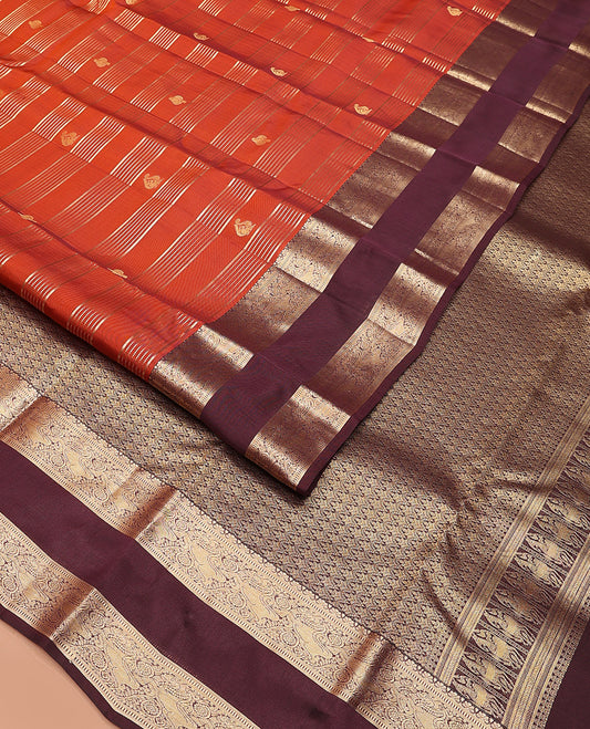 Orange zari buttas and stripes Vasundhara silk mix saree, contrast rettai pettu border of muthu, yaali, and chakram designs, and intricate pallu