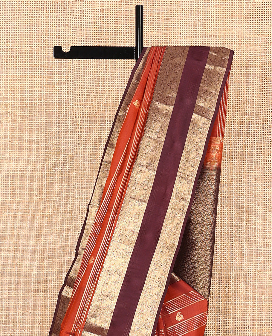 Orange zari buttas and stripes Vasundhara silk mix saree, contrast rettai pettu border of muthu, yaali, and chakram designs, and intricate pallu