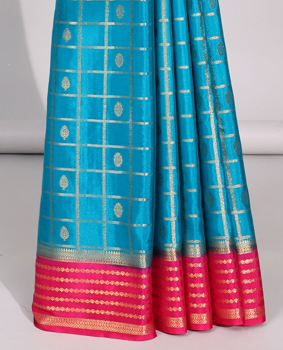 Blue floral motifs enclosed checked with contrast striped zari border & pallu of intricate design
